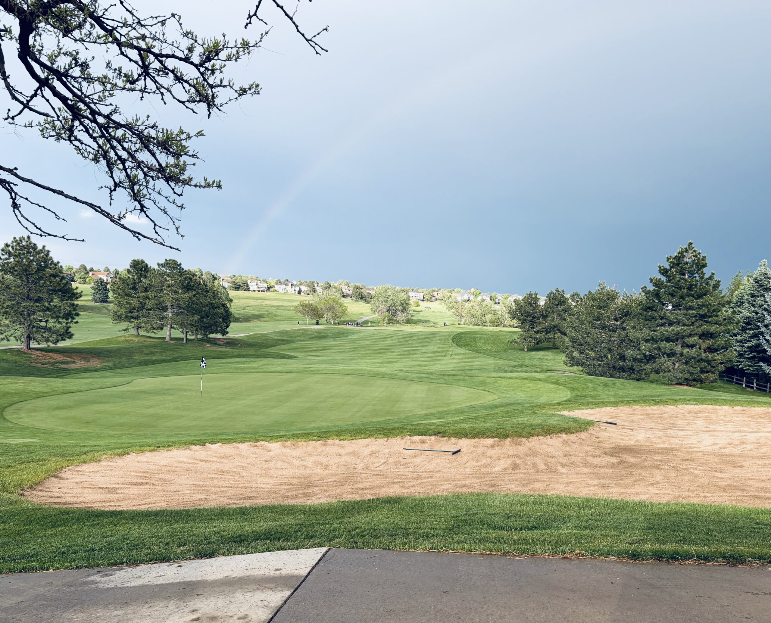 view of golf course with rainbow in the back